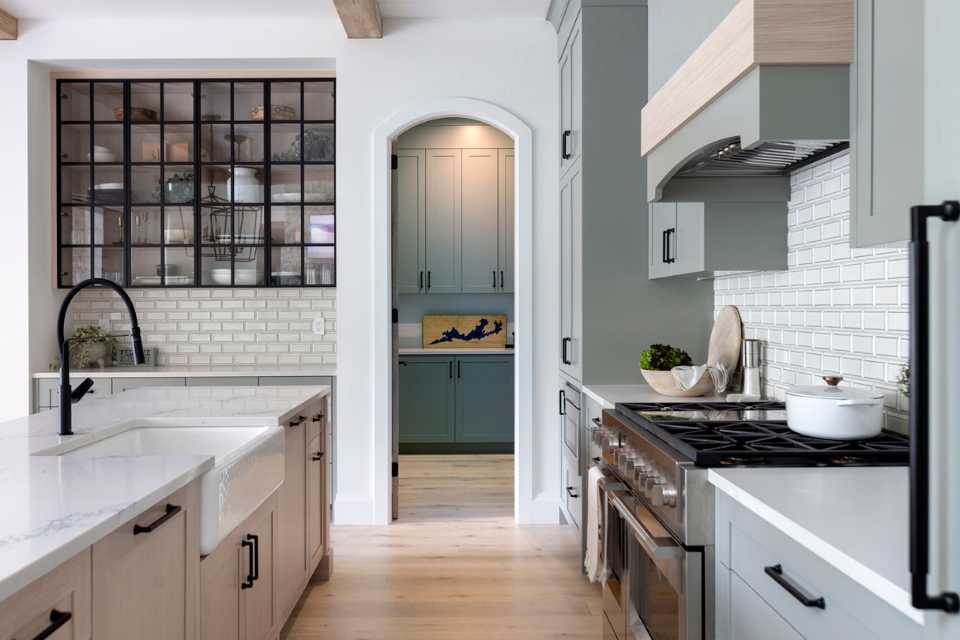 modern farmhouse kitchen layout with arched door to butlers pantry